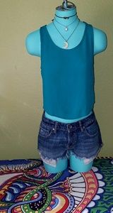 Dark turquoise crop top with knot detailing.